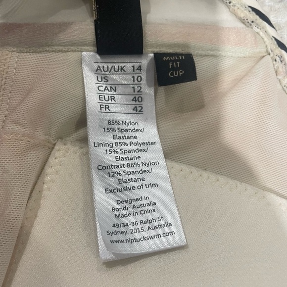 NipTuck cream and black striped swim top. Build in pads and adjustable straps. - Picture 6 of 7